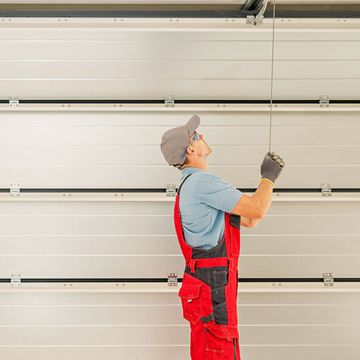 Service Technician repairing a garage door